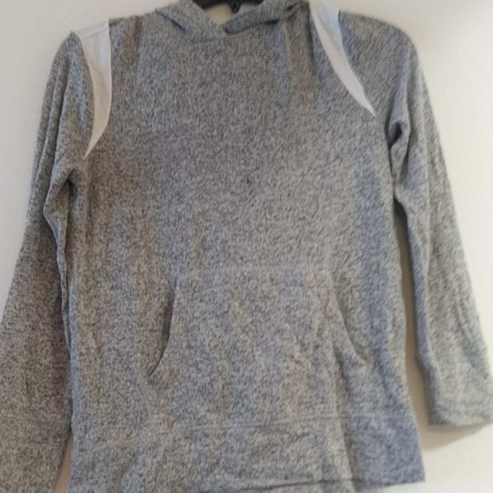 A gray and white shirt with pockets and a hood